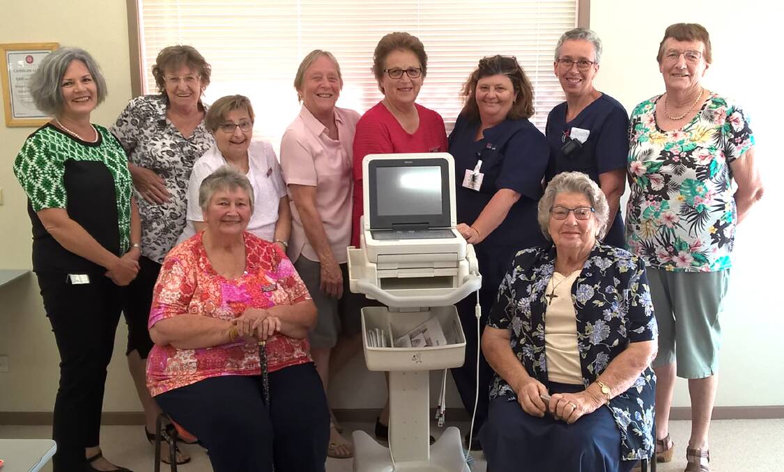 GOOD WORK: (FRONT) Jeanette Schofield and president Win Secombe with the ECG machine. (BACK) Director of Nursing Ann Bodill, volunteers Margaret Mostyn, Debbie Garrett, Lee Kirkpatrick, Judy Allan, hospital staff Leanne Parsons and Denise Holz, and volunteer Verna Wallace.