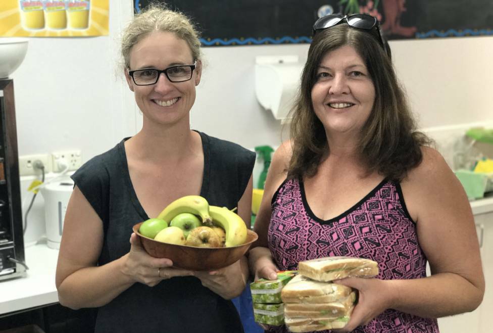 Volunteers Lee Grigg and Alison Drury with food for people affected by the fires. Photo: Letitia Fitzpatrick.