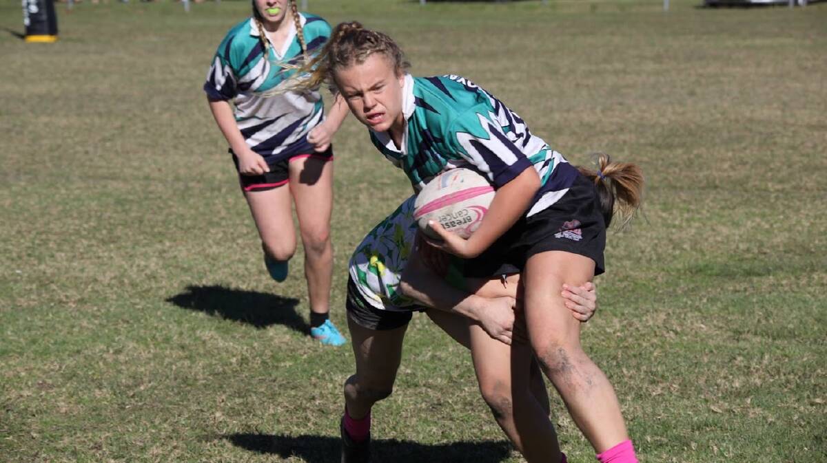Hit and stick: Sacha Everingham is tackled during a match last year. Photo: supplied