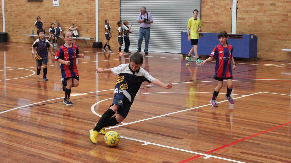 Off for goal: Bradee Maleneack heads for goal in the year 3/4 clash between St Joseph's Wauchope and Port Macquarie Adventist. Photo: supplied