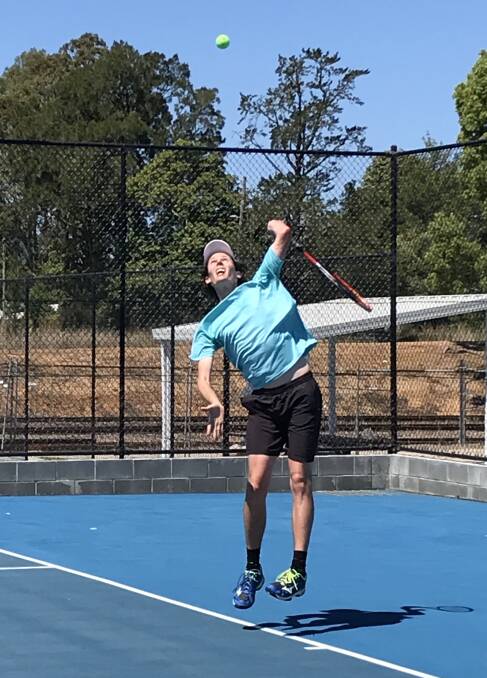 Full extension: Pat Macfetters sends down a serve during the UTR tournament at Kendall over the weekend. Photo: supplied