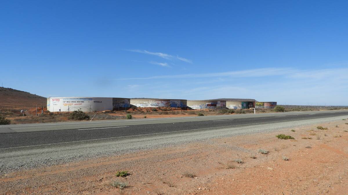 DESERT ART: Graffiti, advertising signs and community notices come together on
roadside water storage tanks near Port Augusta.