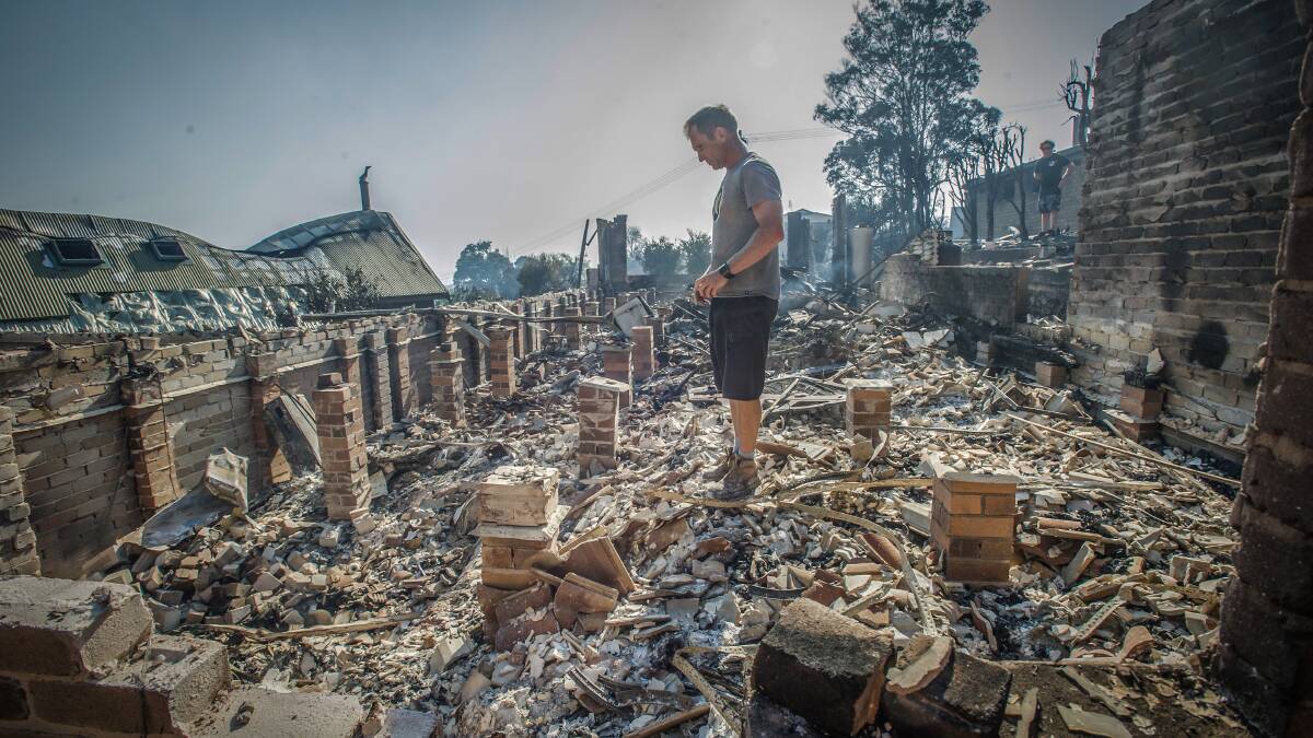 INQUEST: John Blankenstein visits the home of his parents-in-law to see the devastation caused during the Tathra bushfires. Photo: Karleen Minney.