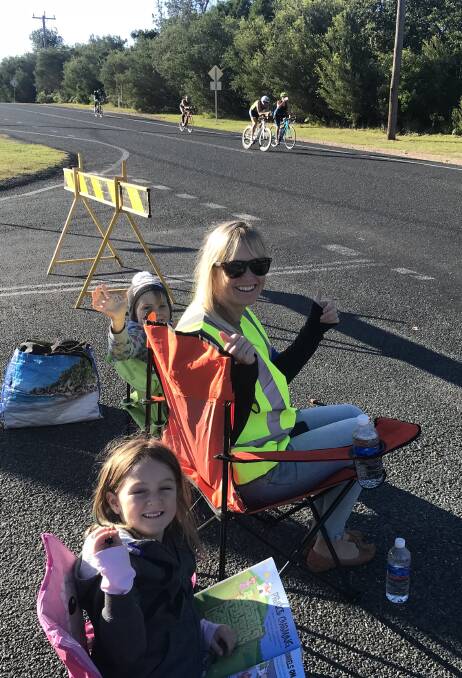  Katie Collins with her children Haley and Cody volunteer their time and spirit as part of Lake Cathie Public School's commitment to support Ironman. PHOTO: supplied