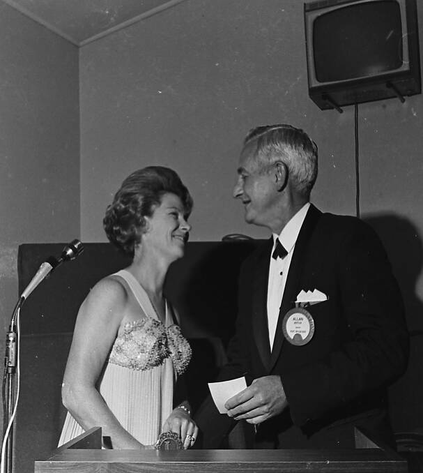 On behalf of the Lions ladies, Mrs Mettam presents a cheque to her husband, Alan Mettam, Port Macquarie Lions Club president, 1971.