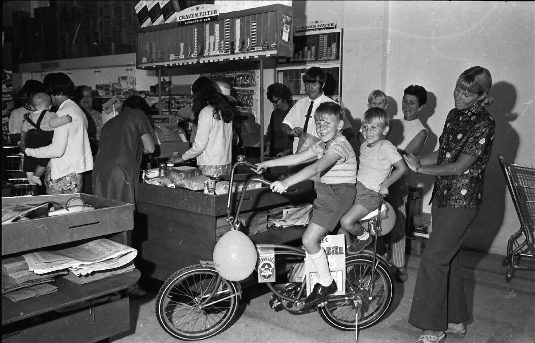 Love to win: Trying out the Dragster Bike prize in the Jones Foodland Store competition during Pioneer Week, 1971.