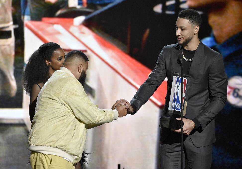 Kelly Rowland, from left, and DJ Khaled present the rookie of the year award to Ben Simmons, of the Philadelphia 76ers, at the NBA Awards in Santa Monica, California. Picture: AP