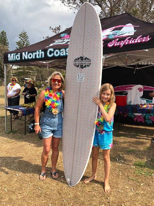  AMAZING: Club president presenting Josie Hoffman with her new Black Square 8ft Mini Mal.
