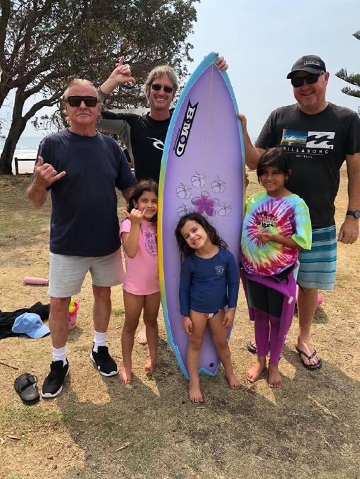 SURF: Ian (Goody) Goodacre BMD, The Villagran Family and Brad McCarthy from BMD presenting Juanita with her new shortboard.
