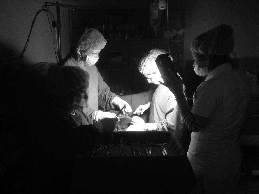 HARSH CONDITIONS: Ray and his team operating under torch light with no power.