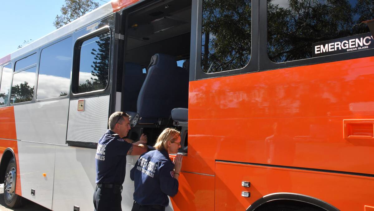 INSPECTION: Fire and Rescue NSW officers inspect the new safety features on the bus. Photo: Ivan Sajko.