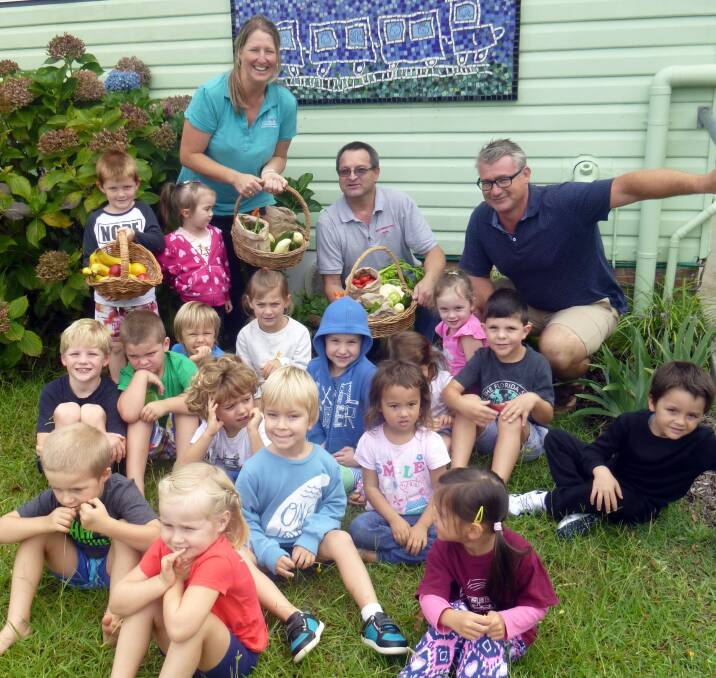 Kendall Community Preschool Director Susan Crowle, Staffan Andler from the Kew Corner Store and MNCLHD Health Promotion Officer Richard Ball with children from Kendall Community Preschool.