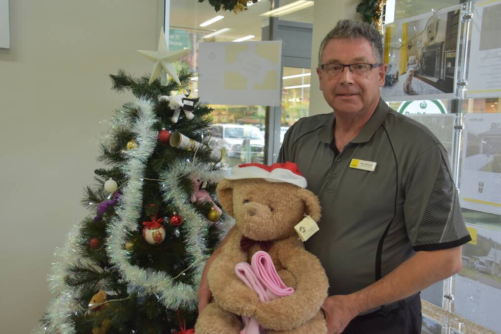 Ray White Laurieton principal Mark Whatson with a donated teddy bear. 
