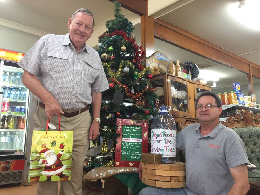 Giving spirit: Theo Hazelgrove from the Camden Haven Community at 3 and Kew Corner Store owner Staffan Andler invite donations of gifts, food and money. 