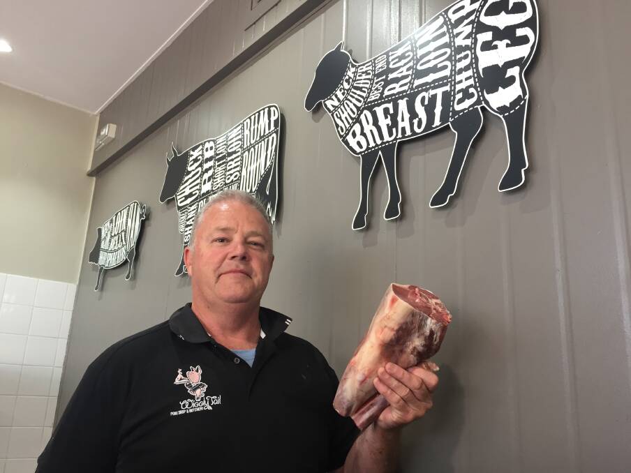 Price hike: Wiggly Tail manager James Ryan holds up lamb that would cost $42 at $18 a kilogram. He said the price of lamb is out of reach for many customers. 