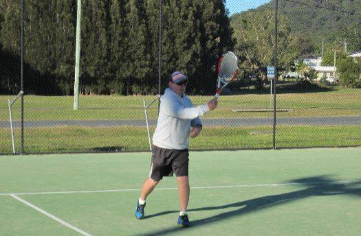 Having a hit: Graeme Grubb enjoys being in the sun playing some tennis at Laurieton Tennis Club in the new group. 