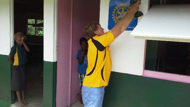 Steve Roberts putting the Rotary Club of Laurieton on the front wall.