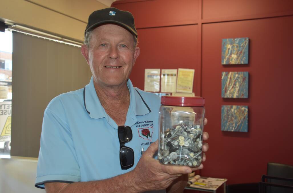 Graham Williams with a jar of screws that his neighbour has been collecting for the last two years. 