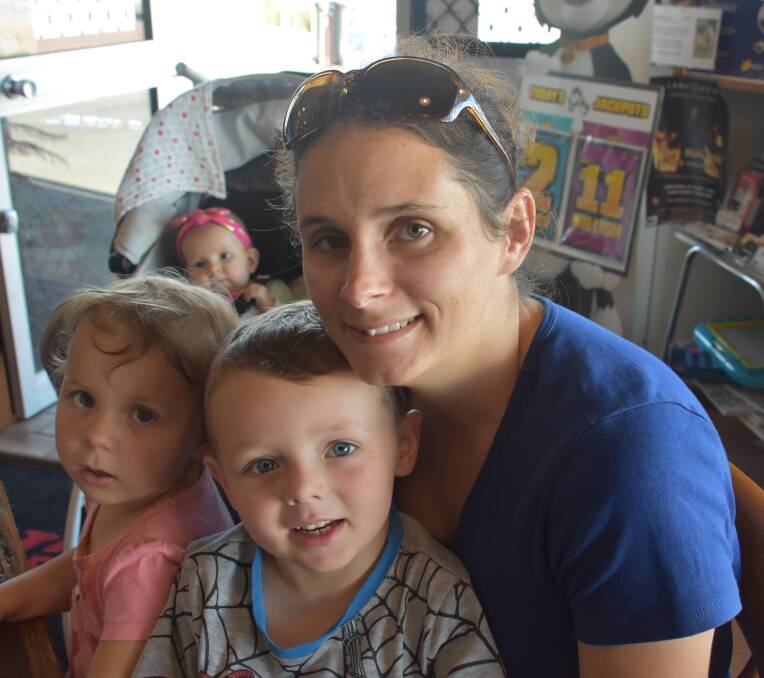 Kristie Neilson with her children Lockie, Josie and Ella (behind). 