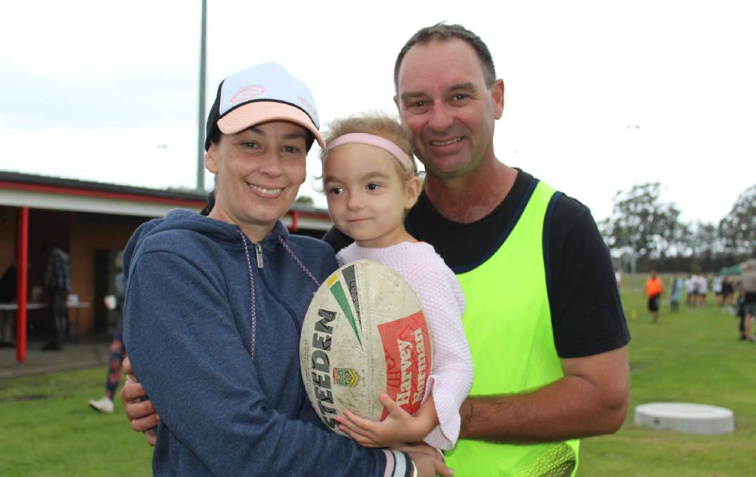 Willow Powick (centre) with her parents Skye and Jeff. 