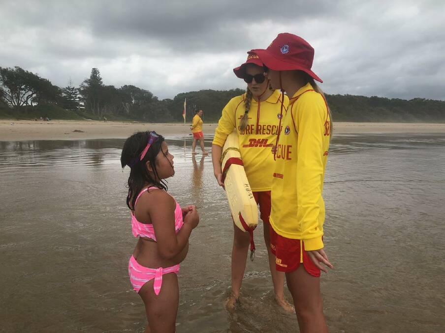 Georgia Bate (Bronze qualified) and Mia Bales (SRC qualified) on patrol speaking with Sydneysider Mia Buckley, whose family was holidaying in Bonny Hills over the Australia Day Long weekend. The girls gave Mia some surf safety tips. Photo:  Leanne Goggin