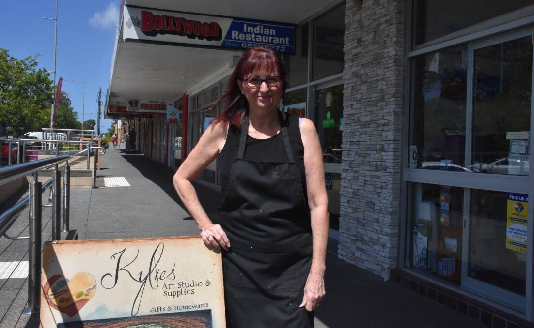 Kylie Johnson from Kylie's Art Studio and Supplies pays a council fee to display her A frame sign. 