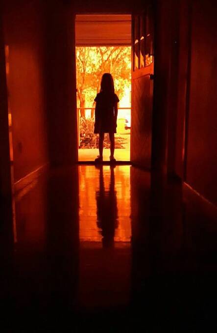 Anxiety and fires: People can call Lifeline Crisis Hotline on 13 11 14. The service is available 24 hours a day. Photo:by Robert Dixon of his nine-year-old daughter. 