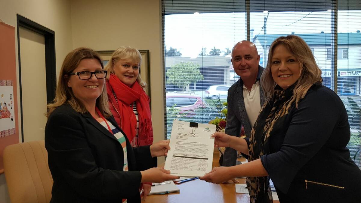 Lake Cathie residents Claire Briggs and Sue East present their petition to Councillor Lee Dixon and Mayor Peta Pinson. Photo: supplied. 