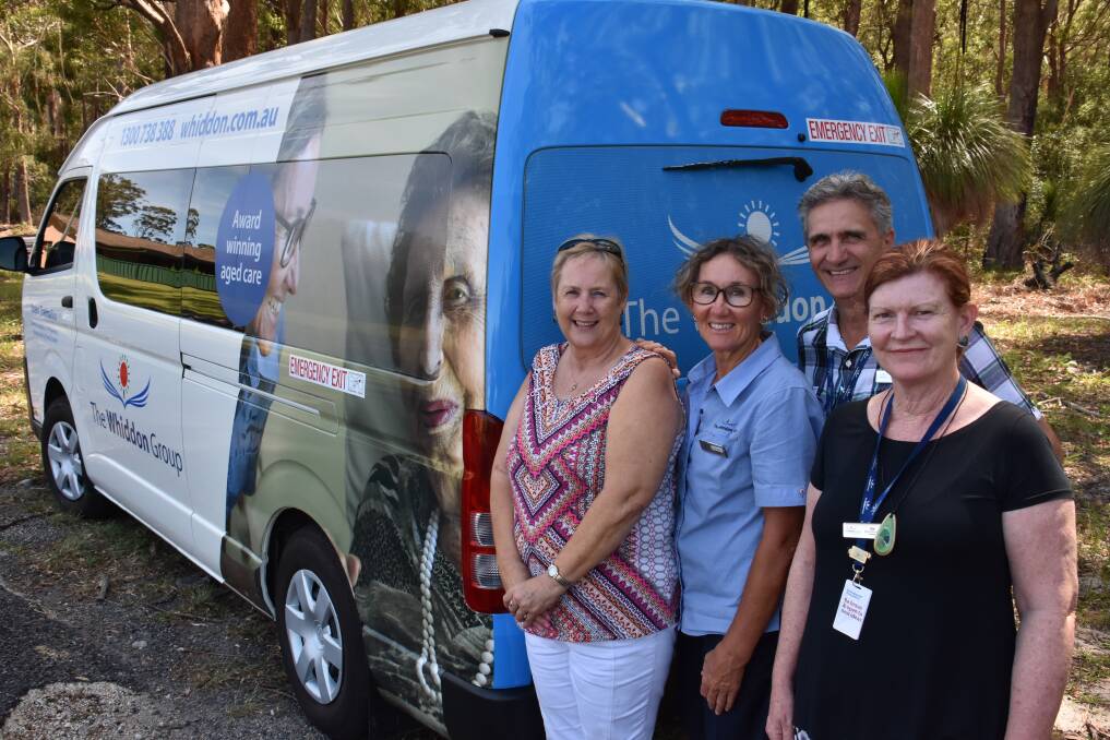 Queen Thelma: The Whiddon Group Laurieton bus is named after the late Thelma Chandler who passed away in 2017. The photograph on the side of the bus shows Thelma with Bernie Adams (assistant in nursing). Pictured: Chrissie Rabinowitz (registered nurse and Thelma's niece), Bernie Adams, director of care services George Fotoulis and deputy director of care Dale Feeney. 