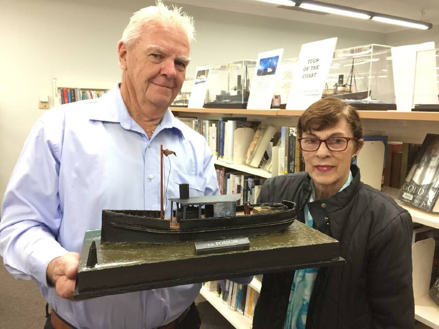 The work horse: Ian Goulding with Lyn Workman say the vessel models give a three dimensional insight into history. A number of tug boat models are on display at Laurieton Library for the month of July. 