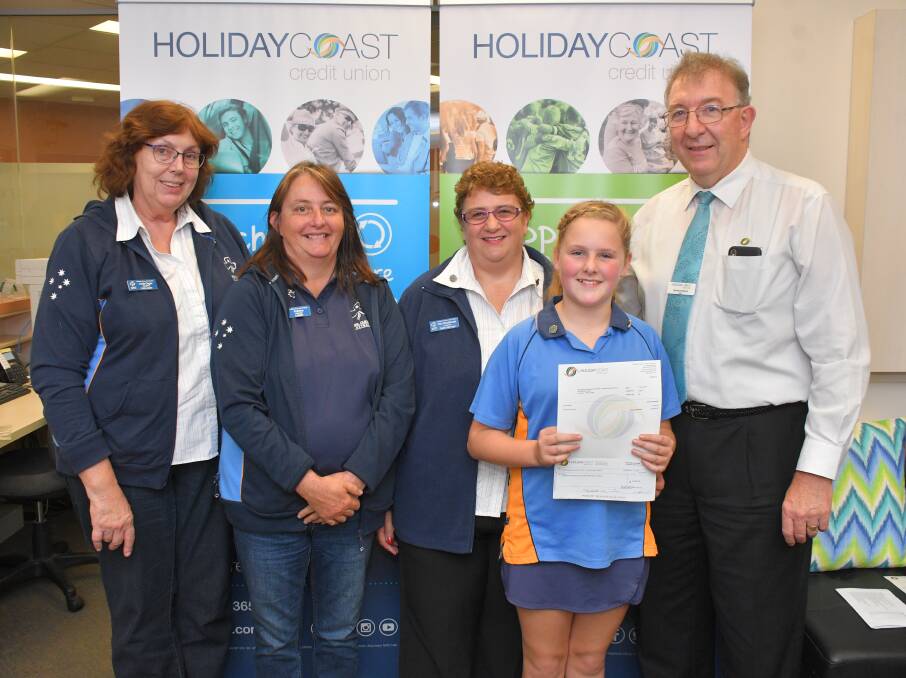 Camden Haven Girl Guide members: Linda Organ, Belinda Schmitzer, Kim Woodhouse, and Evie Millgate accept the grant from Holiday Coast Credit Union CEO Neville Parsons.