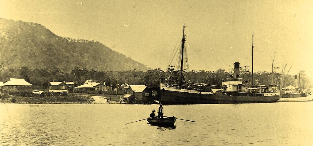 Historic photograph of Laurie Street and Government Wharf in the late 1800s. The photo depicts the Camden Haven Inlet with North Brother Mountain in background. Photo: Camden Haven Historical Society. 