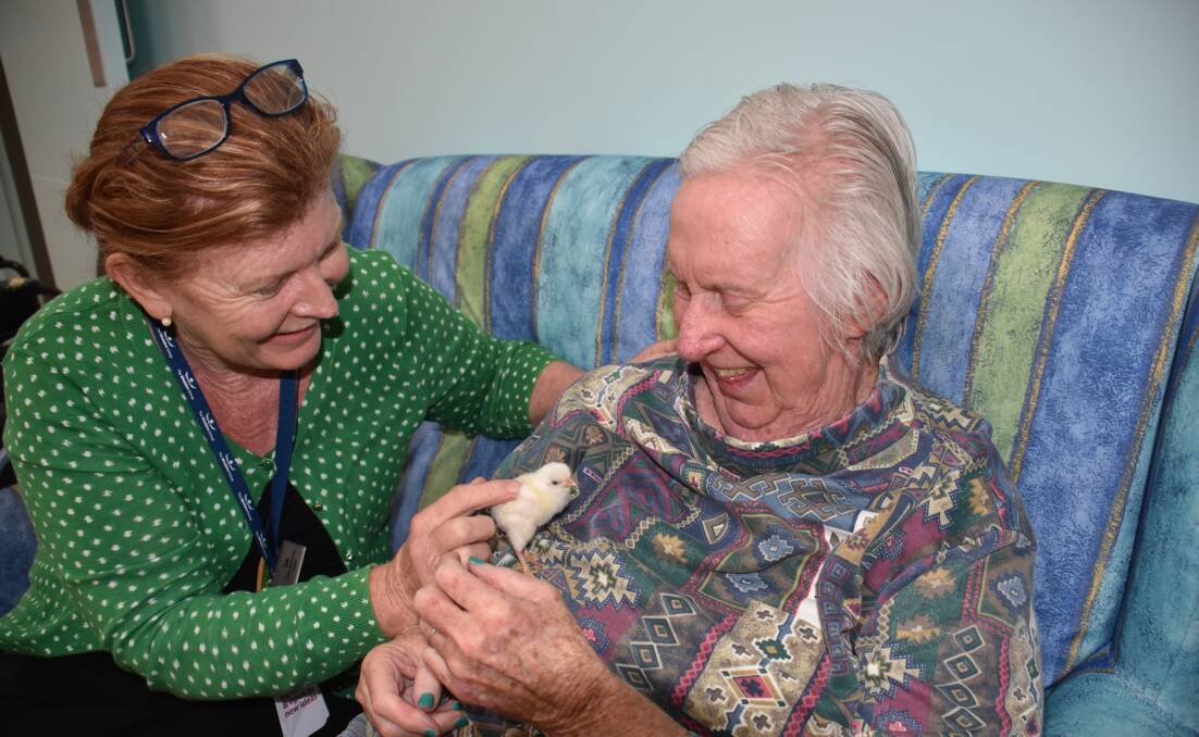 The power of animals: Whiddon Group Laurieton care services deputy director Dale Feeney with resident Kath Burke. 