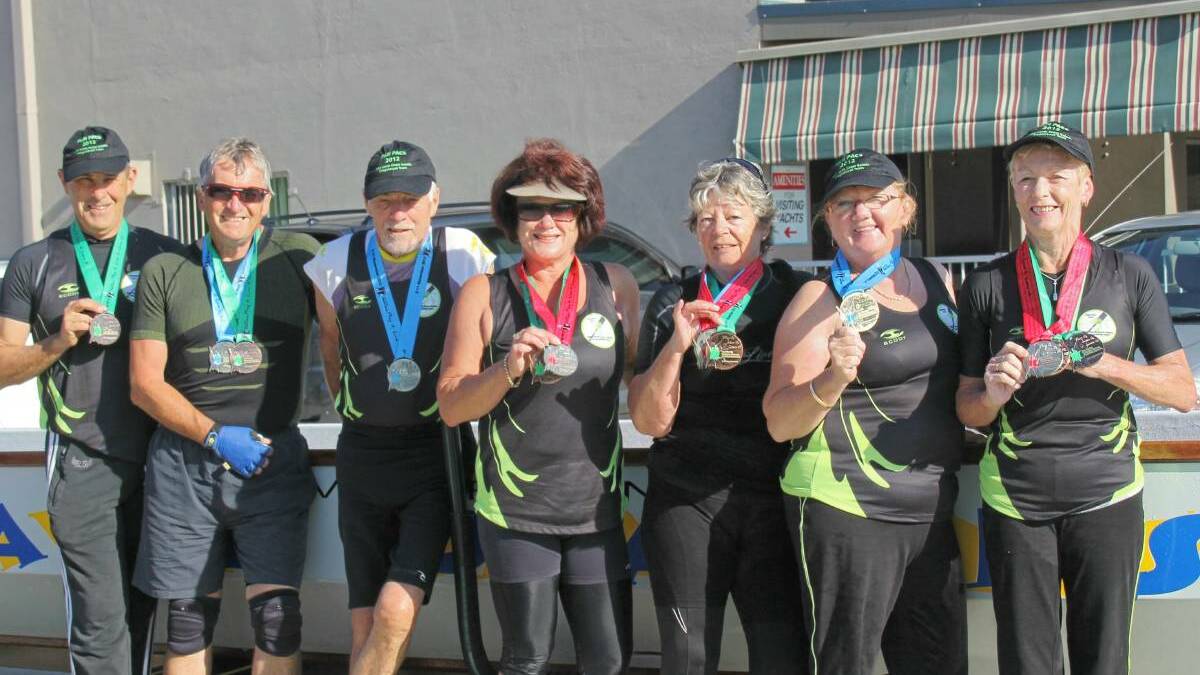 Bringing home the glory: Camden Haven Dragon Boaters with their medals from the 2012 Pan Pacific Games. Pictured are Phil Higgins, Geoff Roberts, Jim Forbes, Jenny Higgins, Marion Roberts, Deb Campbell, Kathy Fry.