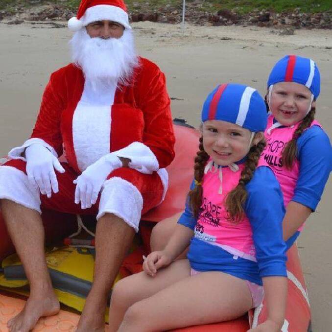 Carols by the Beach: Santa with his helpers from Wauchope Bonny Hills SLSC. 