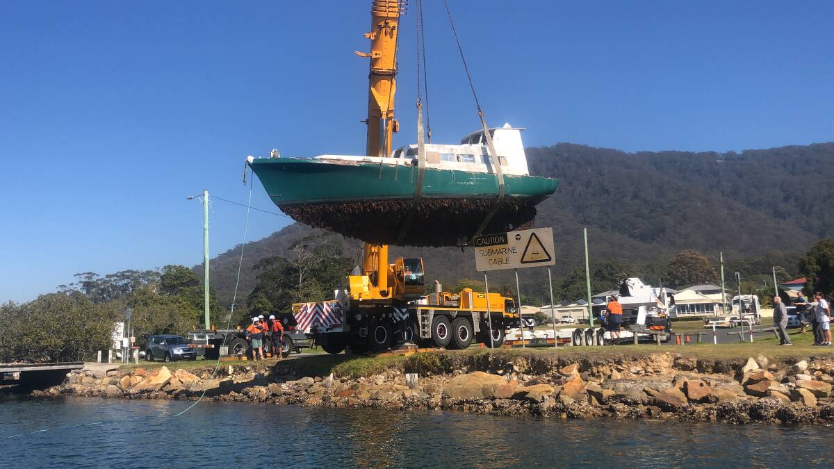 The vessel was removed by crane from the Laurie Street wharf in Laurieton. Photo: supplied. 