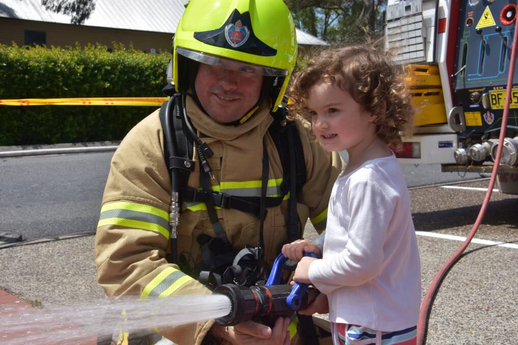Having fun: Firefighter Richard Oakey and Lily Jackson at Laurieton Library in 2018. 