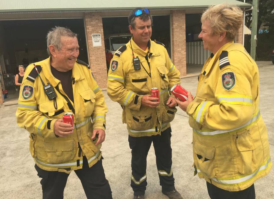 Quick break: The Wauchope RFS grab a coke and share a brief laugh before getting back out there.