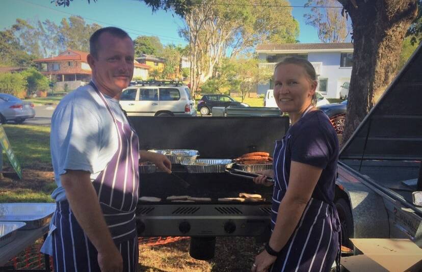 Fundraiser: Todd Harvey and Chloe Gain are on barbecue duty for Lake Cathie Public School P & C  at Lake Cathie Community Centre.