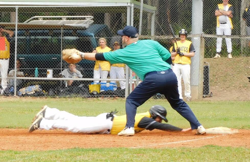 Pirates' runner sliding under an attempted tag by Nathan Ellul. 