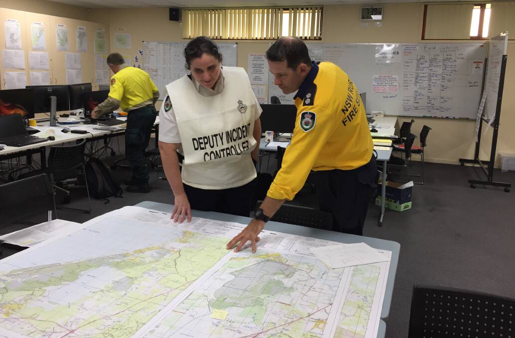 Rural Fire Service's Viki Campbell and Guy Baddock look ahead at weather predictions and plan a strategy.