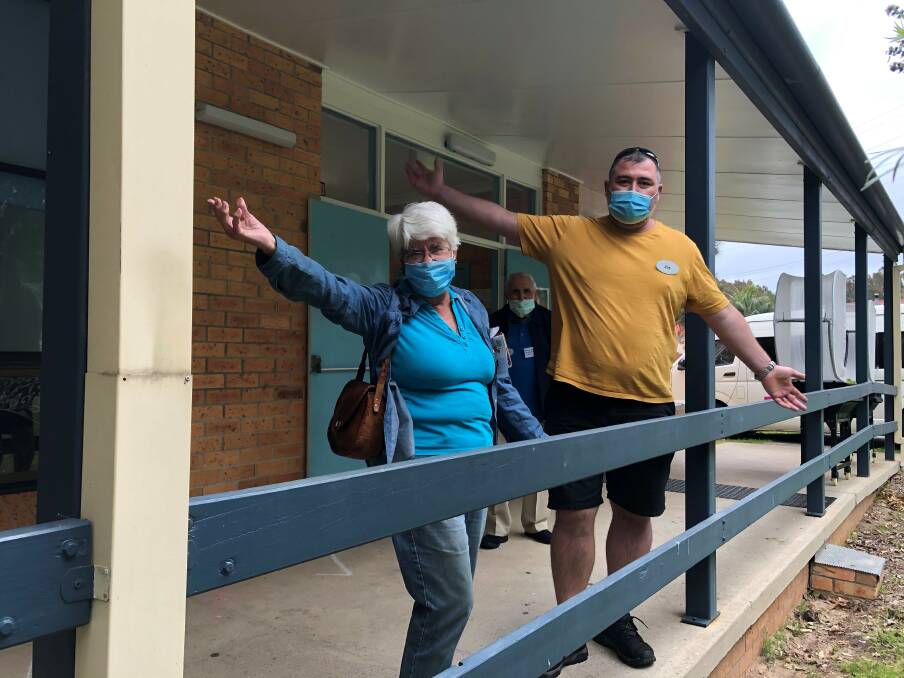 Omnicare SSG regular Beverley Ryder and support worker Jay Rawson offer a warm welcome, while fellow-regular Brian Holtz watches on at Lake Cathie Community Centre.