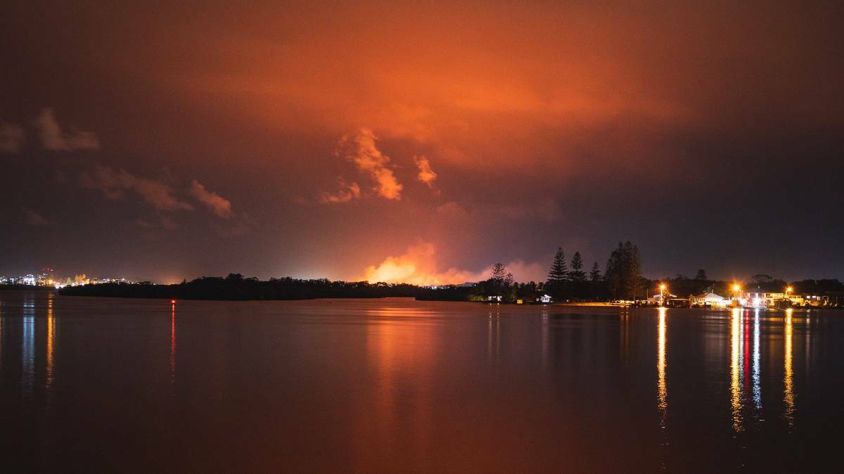 Fire glow: A shot of the Crestwood fire burning overnight as seen from the North Shore of Port Macquarie. Photo: Patrick Linehan. 
