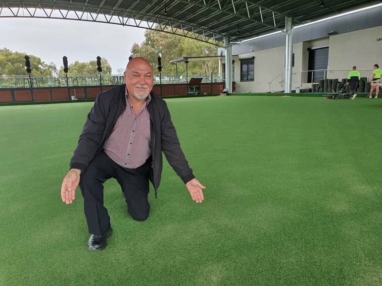 FINAL CONSTRUCTION: Club secretary manager Peter Negus looks over the new turf.