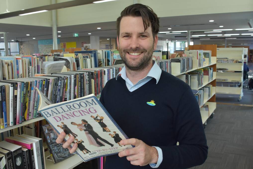 STUDYING UP: Technical services librarian Brendan McDonald at Port Macquarie Library brushing up on his dance knowledge.