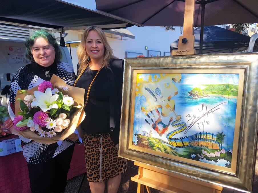 Donated masterpiece: Mayor Peta Pinson unveiling a $110,000 painting donated by Mid-North Coast artist Sharon Davson (left). 