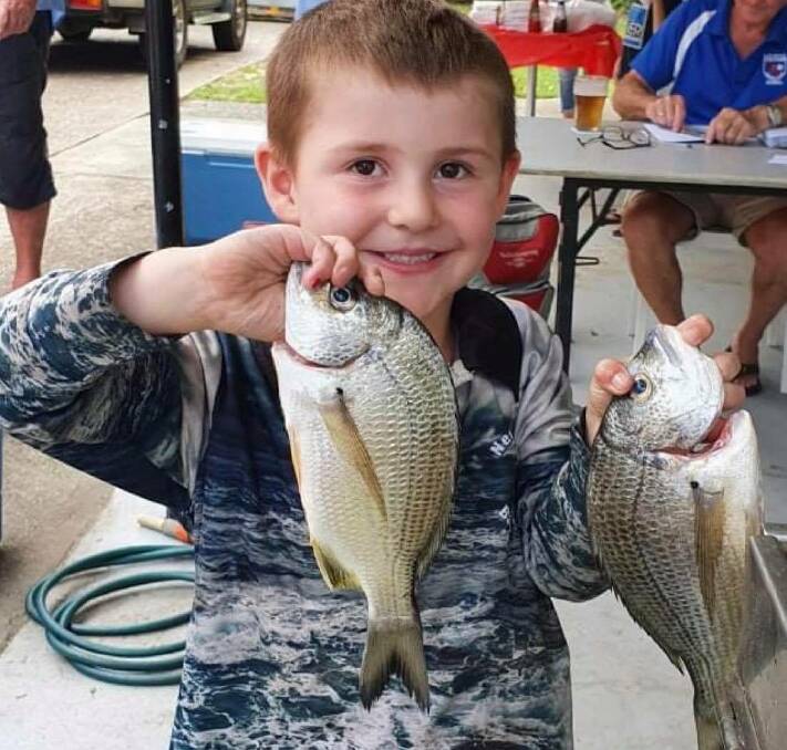BEFORE THE WEIGH IN: Ryder Bryce with his fish at the auction. Photo: Supplied/Rachael Callow.