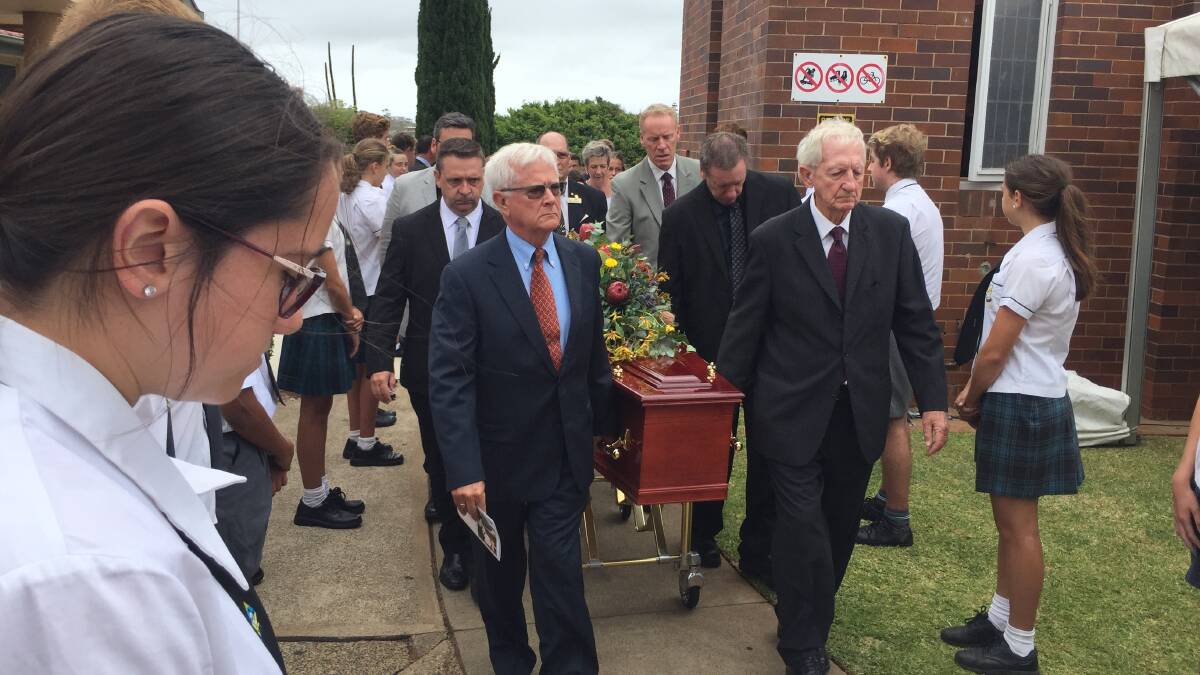 Family, friends and community members pay their respects at his Requiem Mass in the St Agnes' parish church before crowds began forming an honour guard along the Hay, William and Horton Streets.