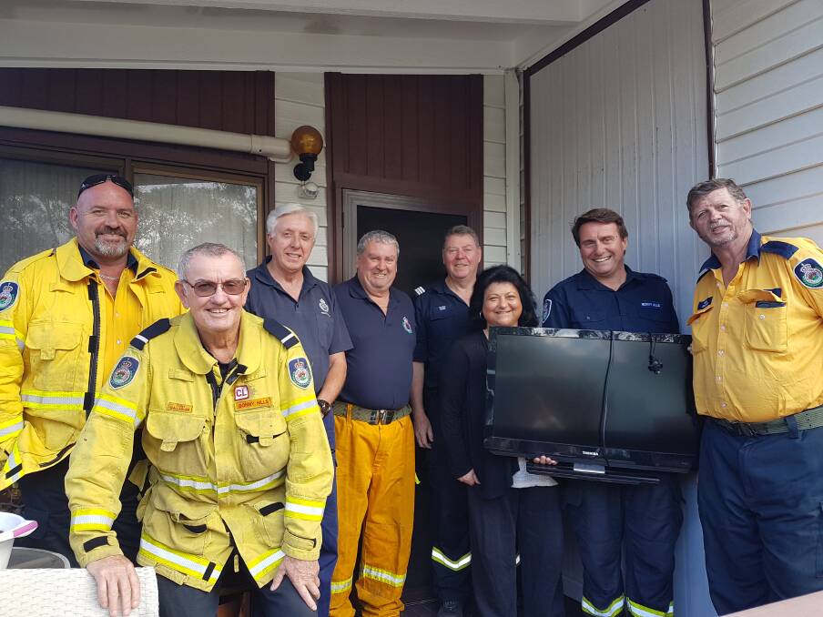 Community effort: Marie Bennett with a television delivered by Bonny Hills Rural Fire Brigade.