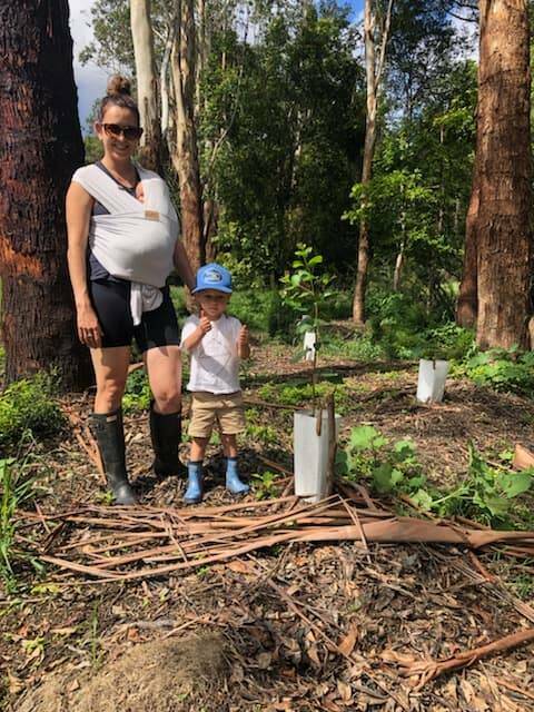 GROWING FAMILY: Taliska Arentsen planting trees at Lorne. Photo: Supplied/Hastings Landcare.